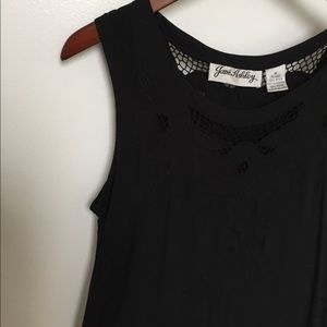 Long sleeveless black dress with eyelet features